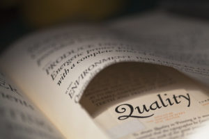 Open book with the word Quality centered
